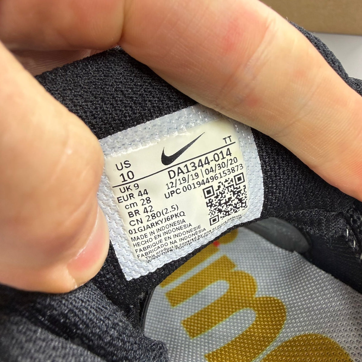 Nike black Air Max 95 trainers with hidden message detail and sleek design.