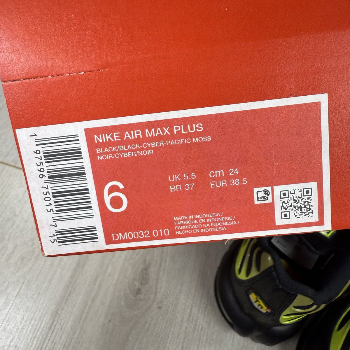 Nike Air Max Plus TN trainers black with moss green accents and signature logo.