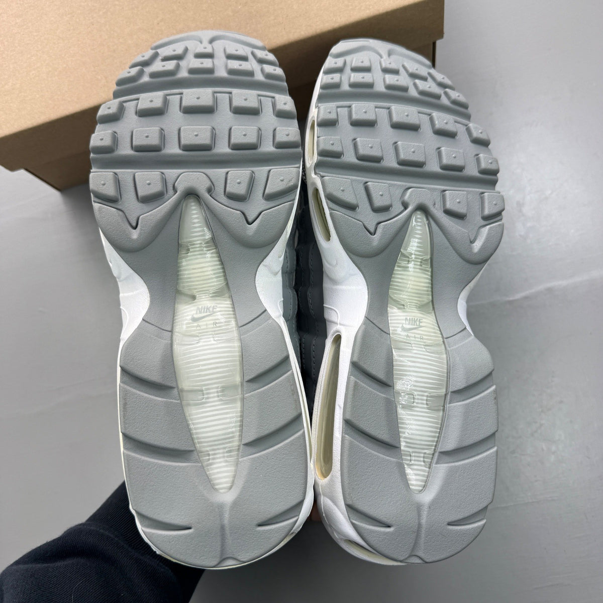 Nike Air Max 95 grey sneaker with white accents and reflective detailing.