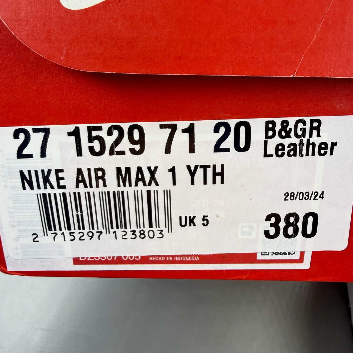 Nike Air Max 1 black trainers with silver and white accents, featuring iconic logo.