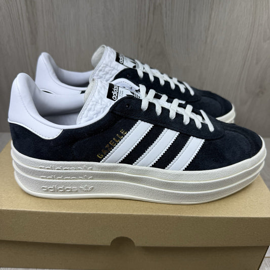 Adidas Gazelle Bold black trainers with white stripes and logo detailing.