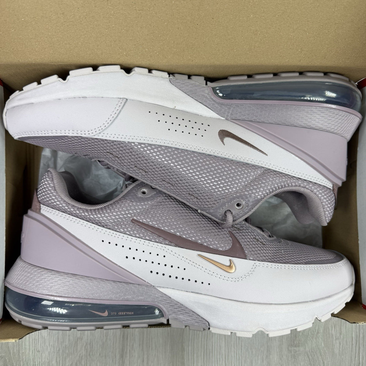 Nike Air Max Pulse purple trainers with unique design and textured material.