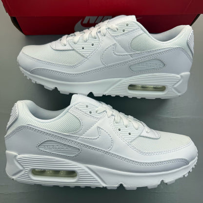 Nike Air Max 90 white trainers with iconic swoosh logo and breathable mesh material.