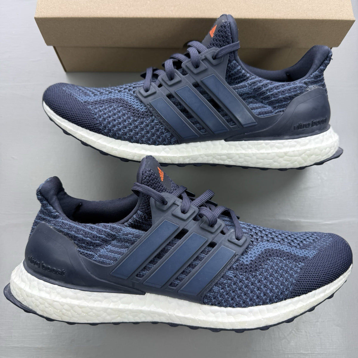 Adidas Ultra Boost 5.0 DNA trainers in navy blue with white accents and logo.