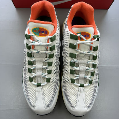 Nike Air Max 95 trainers white with safari green accents and textured material.