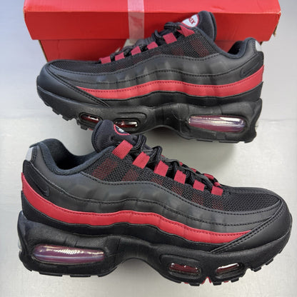Nike Air Max 95 black trainers with crimson red accents and grey detailing.