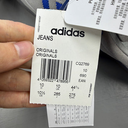 Adidas grey deck shoes with suede material and logo detail.