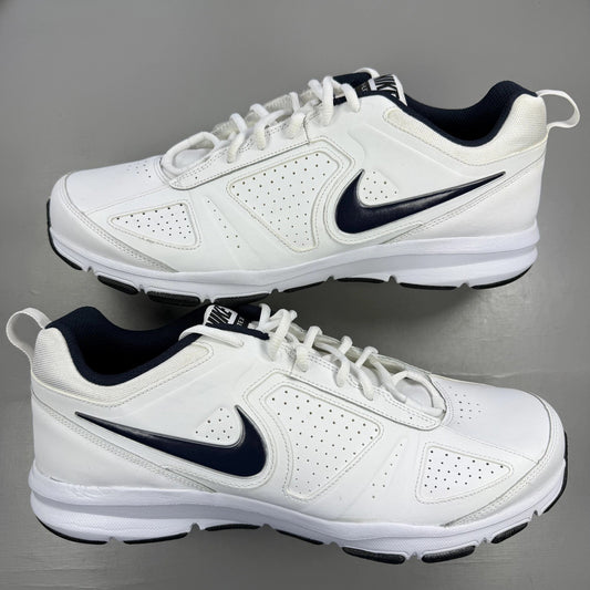 Nike white trainers with navy and black accents, featuring logo and breathable mesh material.