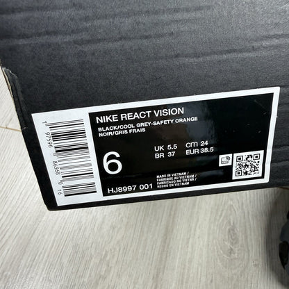 Nike React Vision black and grey trainers with safety orange accents and unique design.