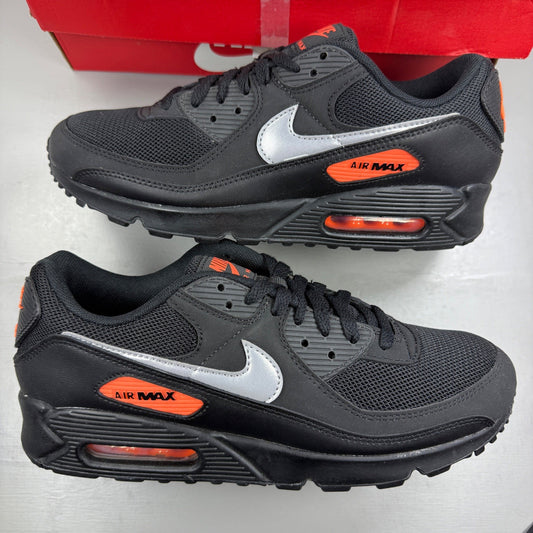 Nike Air Max 90 black sneaker with total orange accents and reflective silver details.