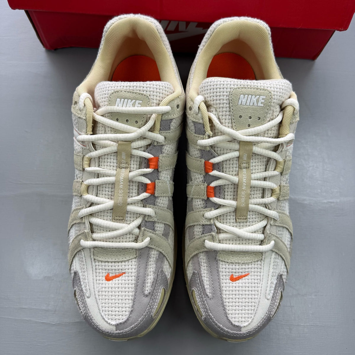 Nike P-6000 grey trainers with mesh upper and subtle logo detailing.