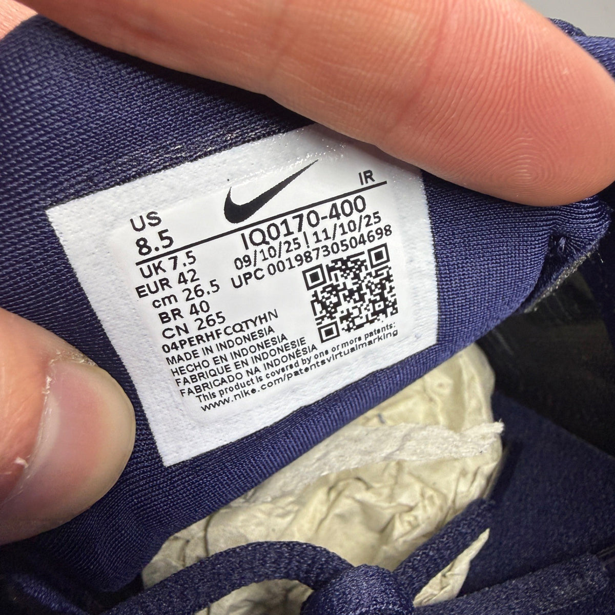 Nike running shoes metallic blue with copper accents and signature logo.