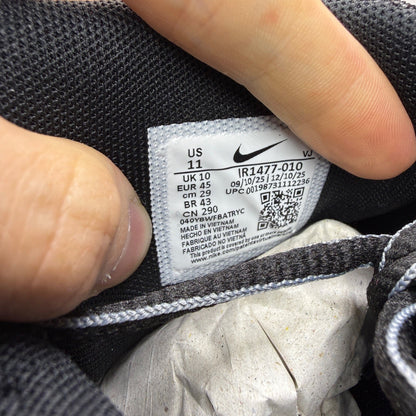Nike black trainers with grey and turquoise accents, featuring a sleek mesh upper.