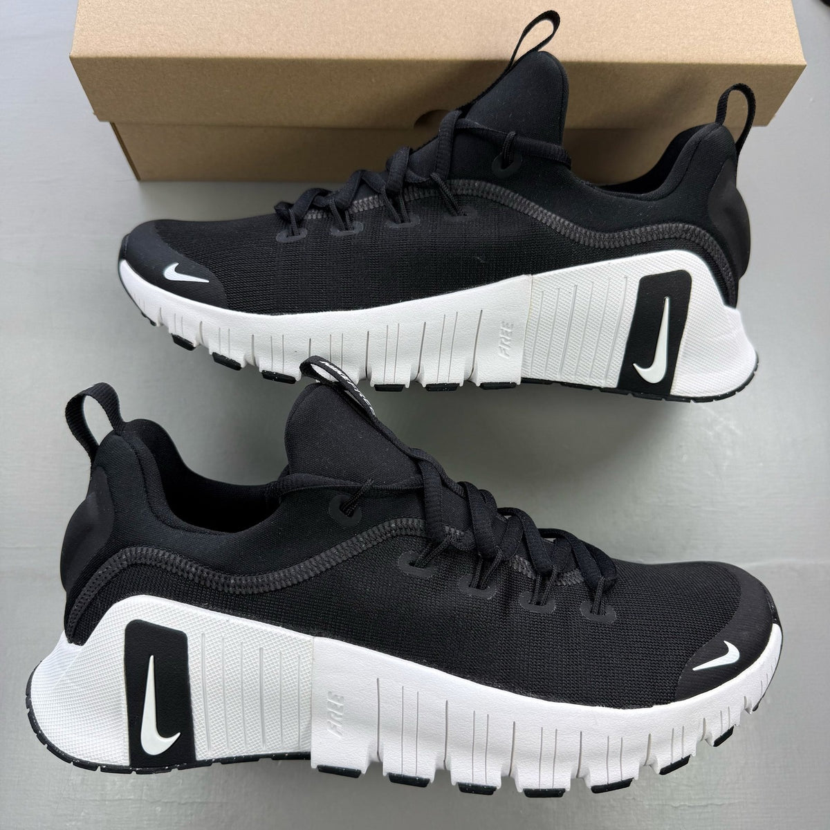 Nike black trainers with white accents and breathable mesh upper.