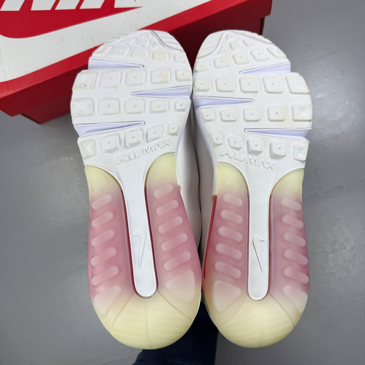 Nike running shoes white with red accents and logo, featuring a sleek design.