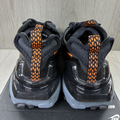 Nike React Vision black trainers with safety orange accents and unique design details.