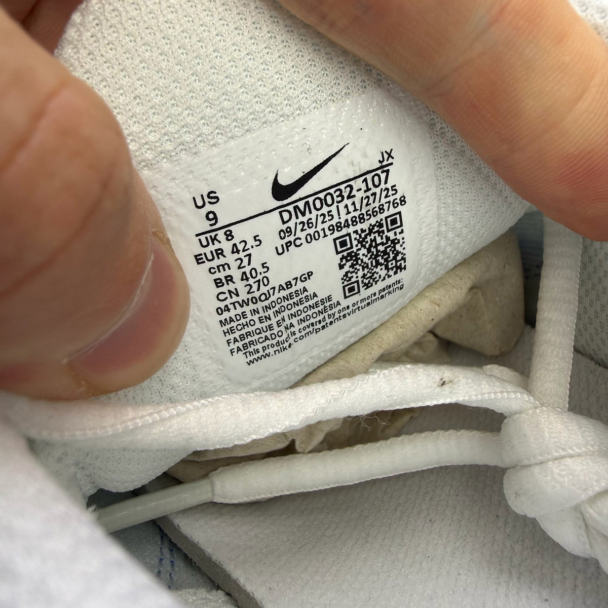Nike Air Max Plus TN white trainers with blue accents and signature logo.
