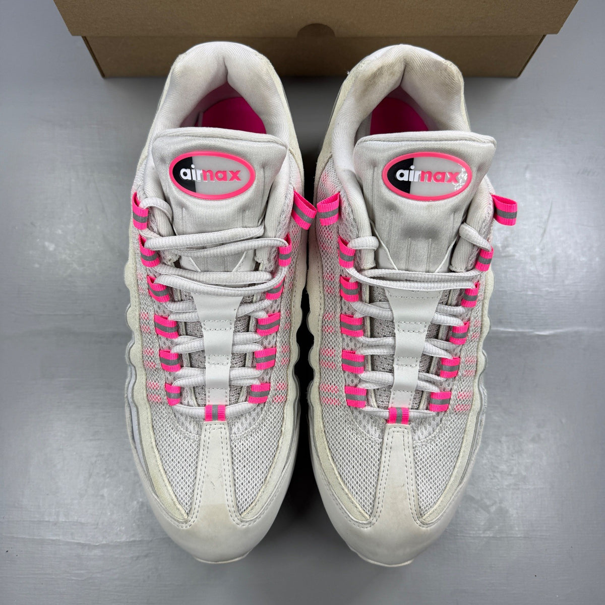 Nike running shoes white with pink accents and visible logo details.