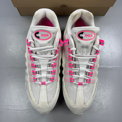 Nike running shoes white with pink accents and visible logo details.