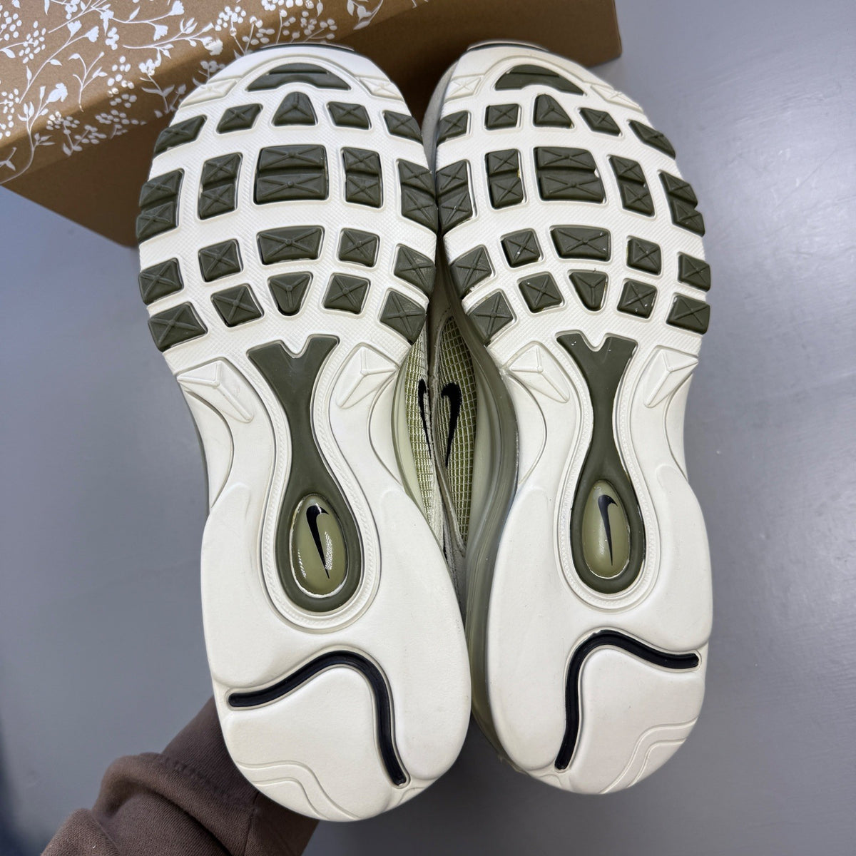 Nike trainers green with light bone accents and Air Max cushioning design.