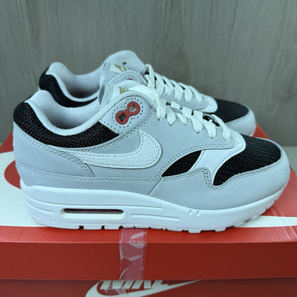Nike Air Max 1 trainers grey with white accents and signature swoosh logo.