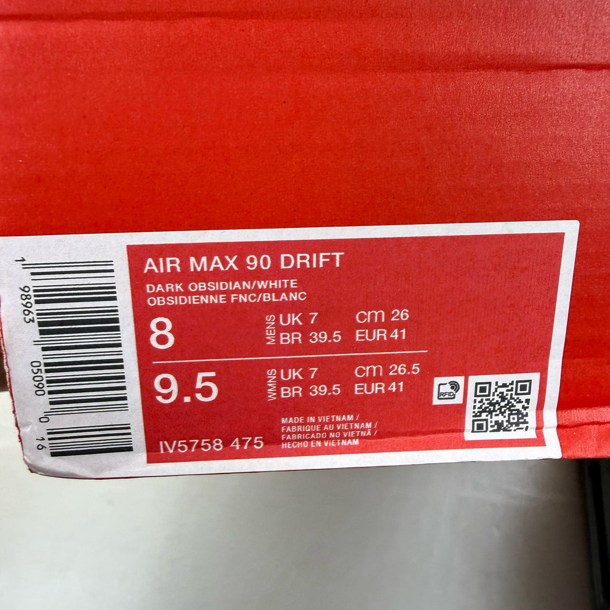 Nike Air Max 90 blue trainers with white accents and logo detail.