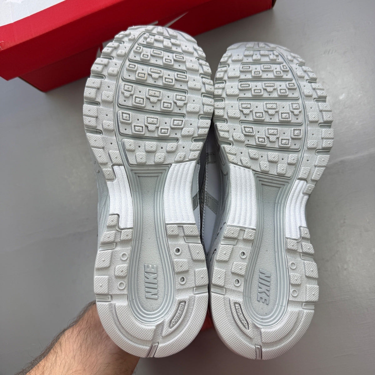 Nike deck shoes silver with logo details and sleek design.