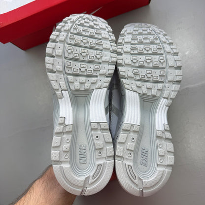 Nike deck shoes silver with logo details and sleek design.