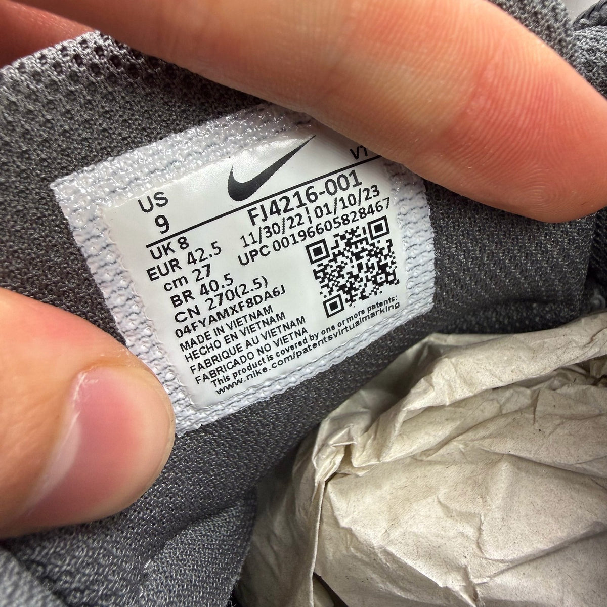 Nike Air Max 95 grey trainers with blue accents and visible logo detailing.
