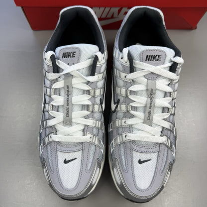 Nike P-6000 trainers metallic silver with white and grey accents, mesh material.