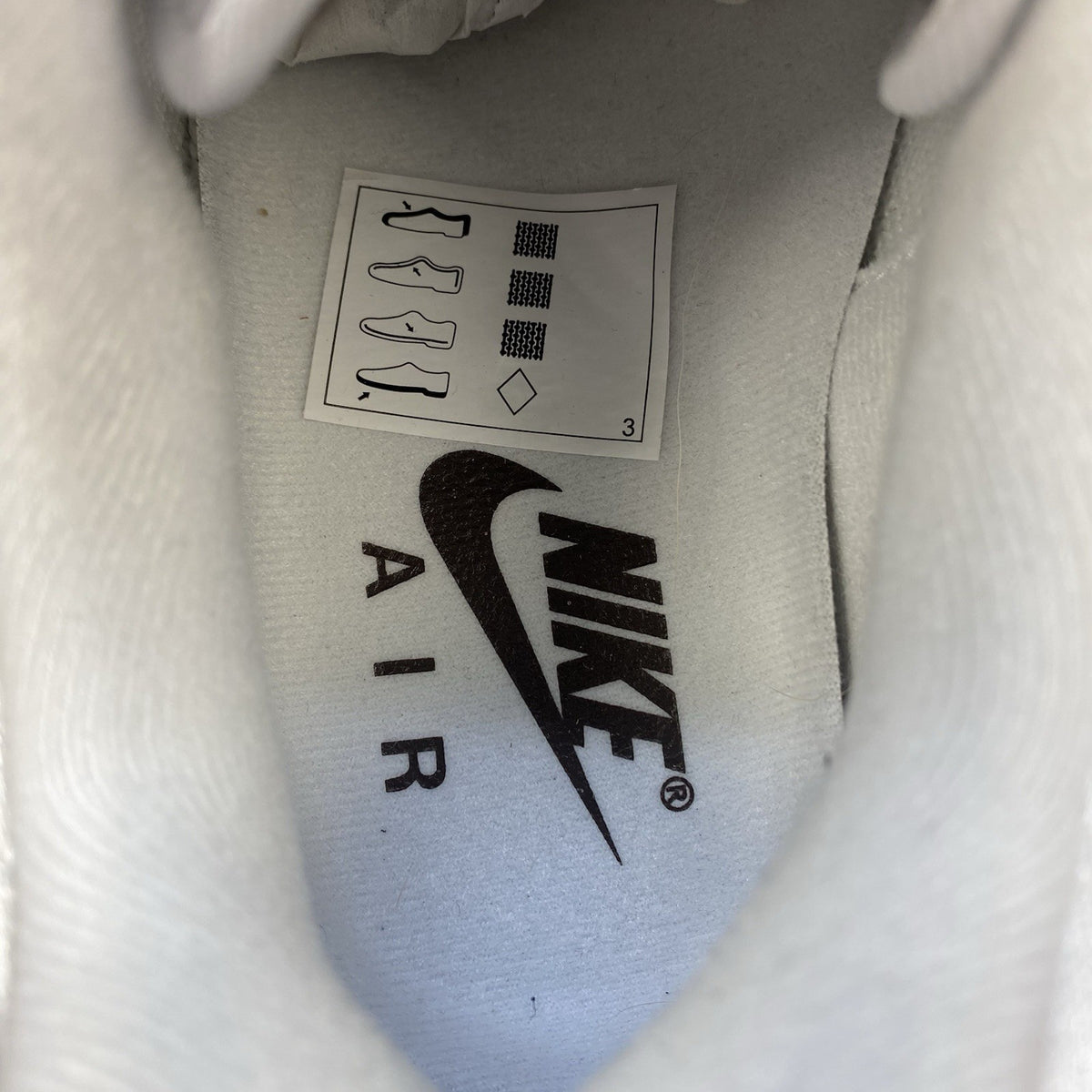 Nike Air Max 1 '87 trainers white with grey accents and brown detailing.