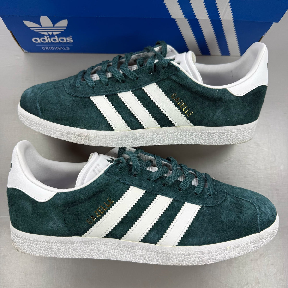Adidas green suede Gazelle trainers with white stripes and logo detail.
