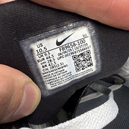 Nike Air Max 90 grey trainers with red accents and gum sole, featuring logo details.