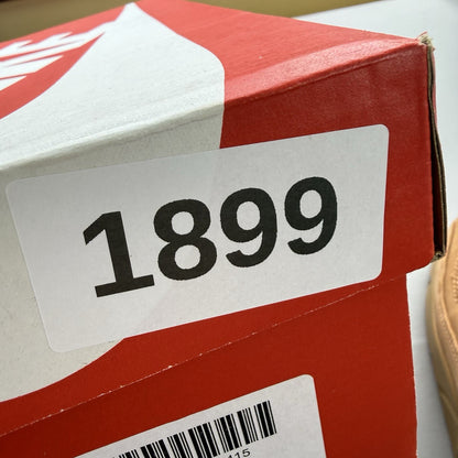 Nike Air Max 90 Premium beige trainers with gum sole and subtle branding details.