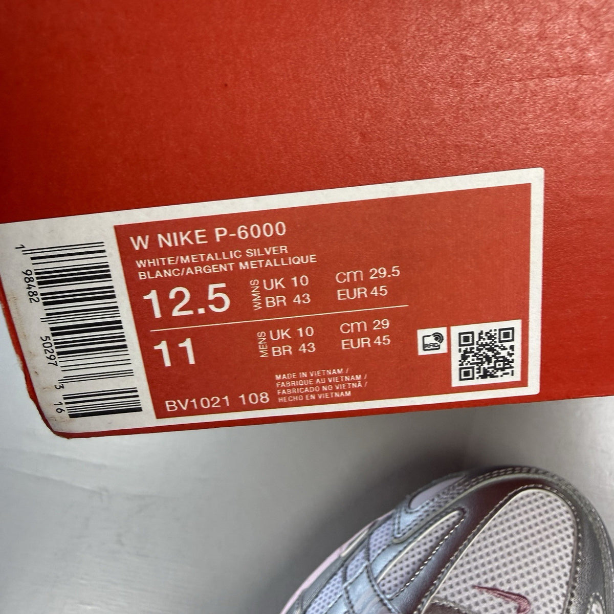 Nike P-6000 white trainers with elemental pink and silver accents, featuring logo details.