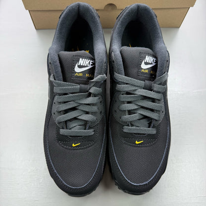 Nike Air Max 90 black trainers with speed yellow accents and signature logo details.