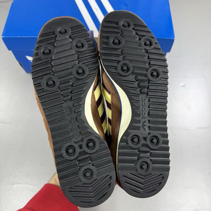 Adidas brown trainers with retro design and classic logo detail.