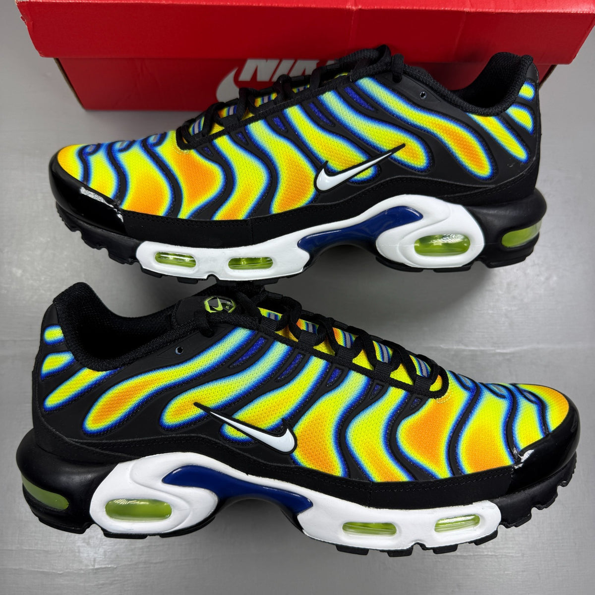 Nike athletic shoes yellow with heat map pattern and black accents.