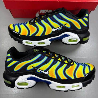 Nike athletic shoes yellow with heat map pattern and black accents.