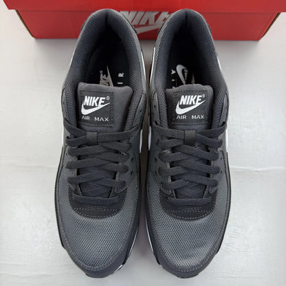 Nike Air Max 90 grey trainers with black and white accents, featuring logo details.