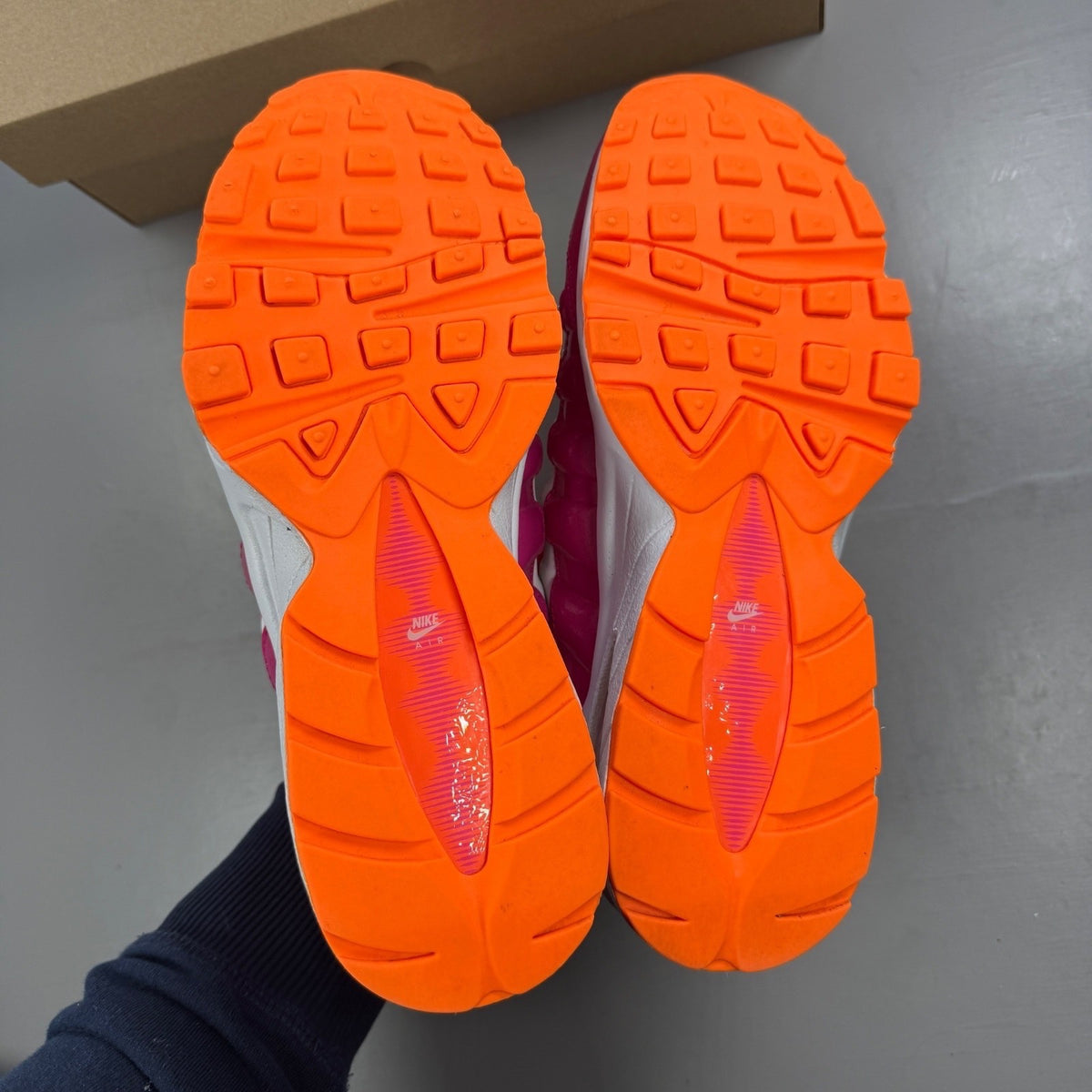 Nike running shoes vivid pink and white with mesh upper and Air Max cushioning.