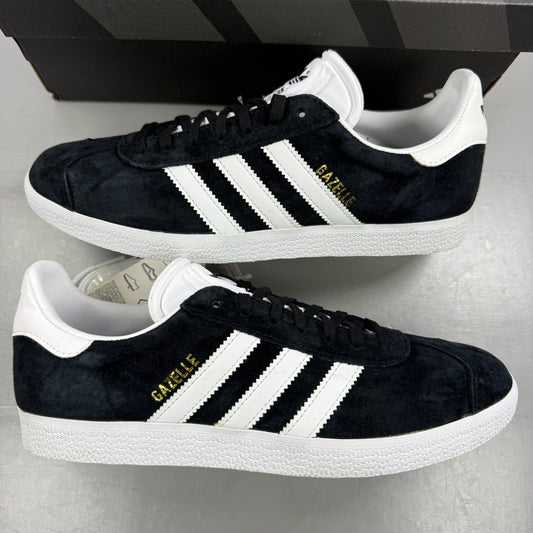 Adidas black athletic shoes with white stripes and logo, size UK 7.5.
