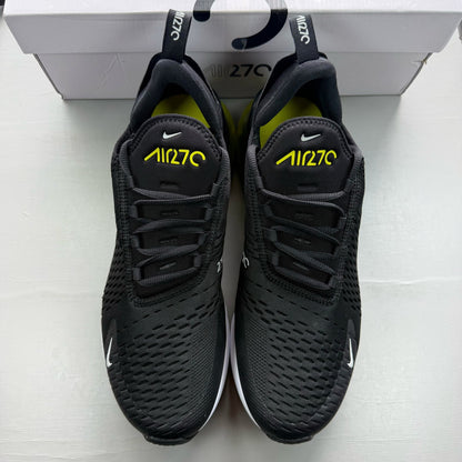 Nike black trainers with Opti Yellow accents and Air Max cushioning.