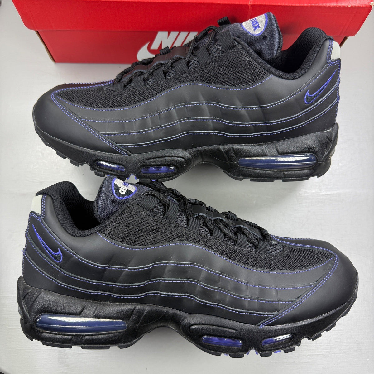 Nike Air Max 95 black sneakers with Persian Violet accents and signature logo.