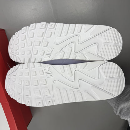 Nike Air Max 90 white trainers with light crimson accents and signature swoosh logo.