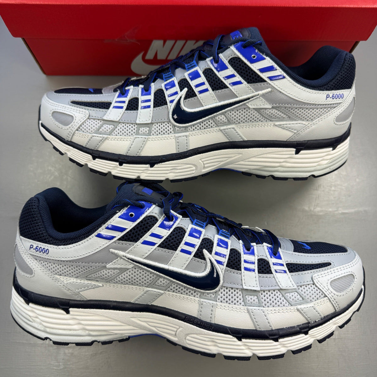 Nike deck shoes grey with blue eclipse accents and white sole, featuring logo detail.