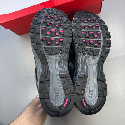 Nike P-6000 grey trainers with pink and black accents, mesh upper and logo detail.