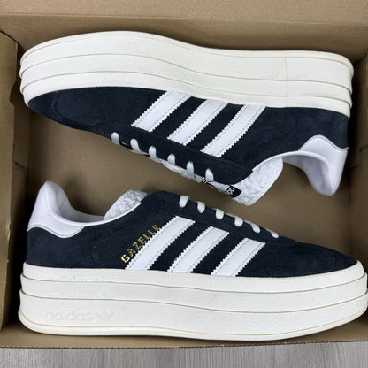 Adidas Gazelle Bold black trainers with white stripes and logo detailing.