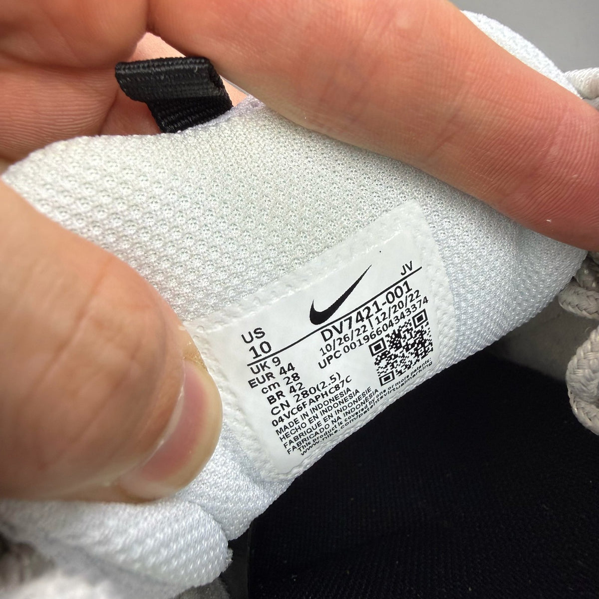 Nike Air Max 97 white trainers with grey and navy accents, featuring iconic swoosh logo.