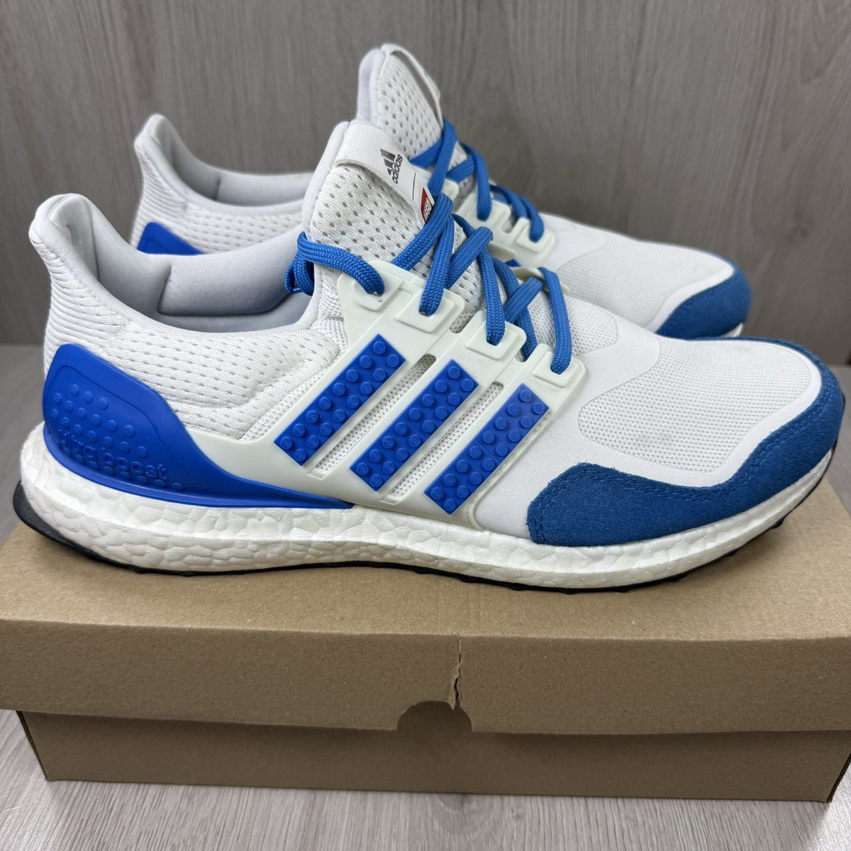 Adidas grey Ultra Boost trainers with blue accents and distinctive LEGO branding.